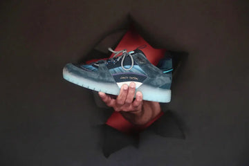 person holding gray and white nike athletic shoe