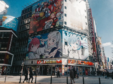 Building with large anime billboards in a city