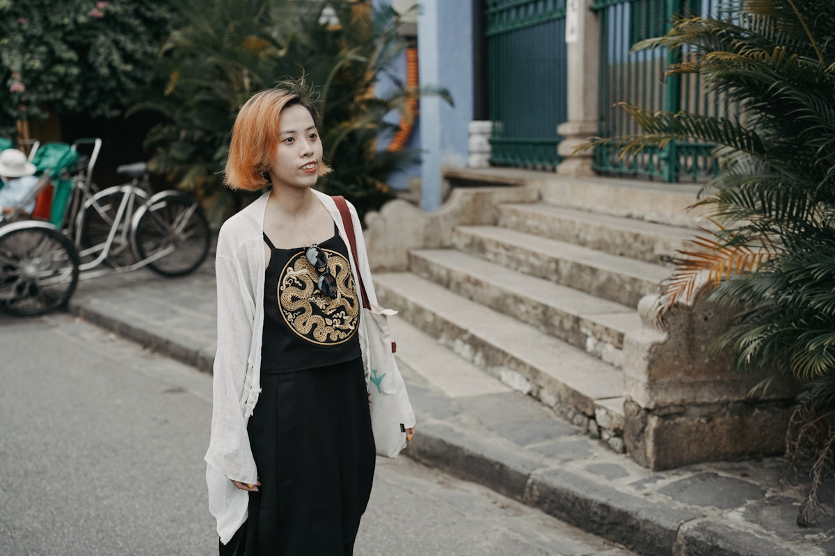 a woman with red hair walking down a street