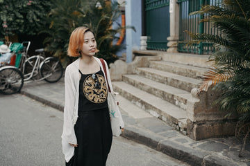 a woman with red hair walking down a street