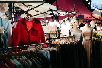 a woman is looking at a display of clothing