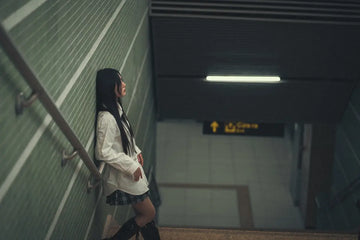 a woman is standing on a set of stairs