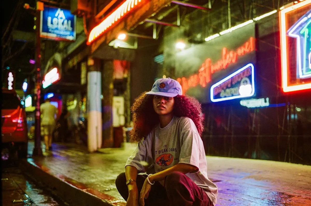 A person sitting on a skateboard on a city street