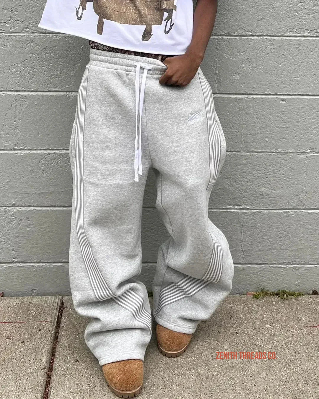 Light gray sweatpants with ribbed detailing and drawstring waist.