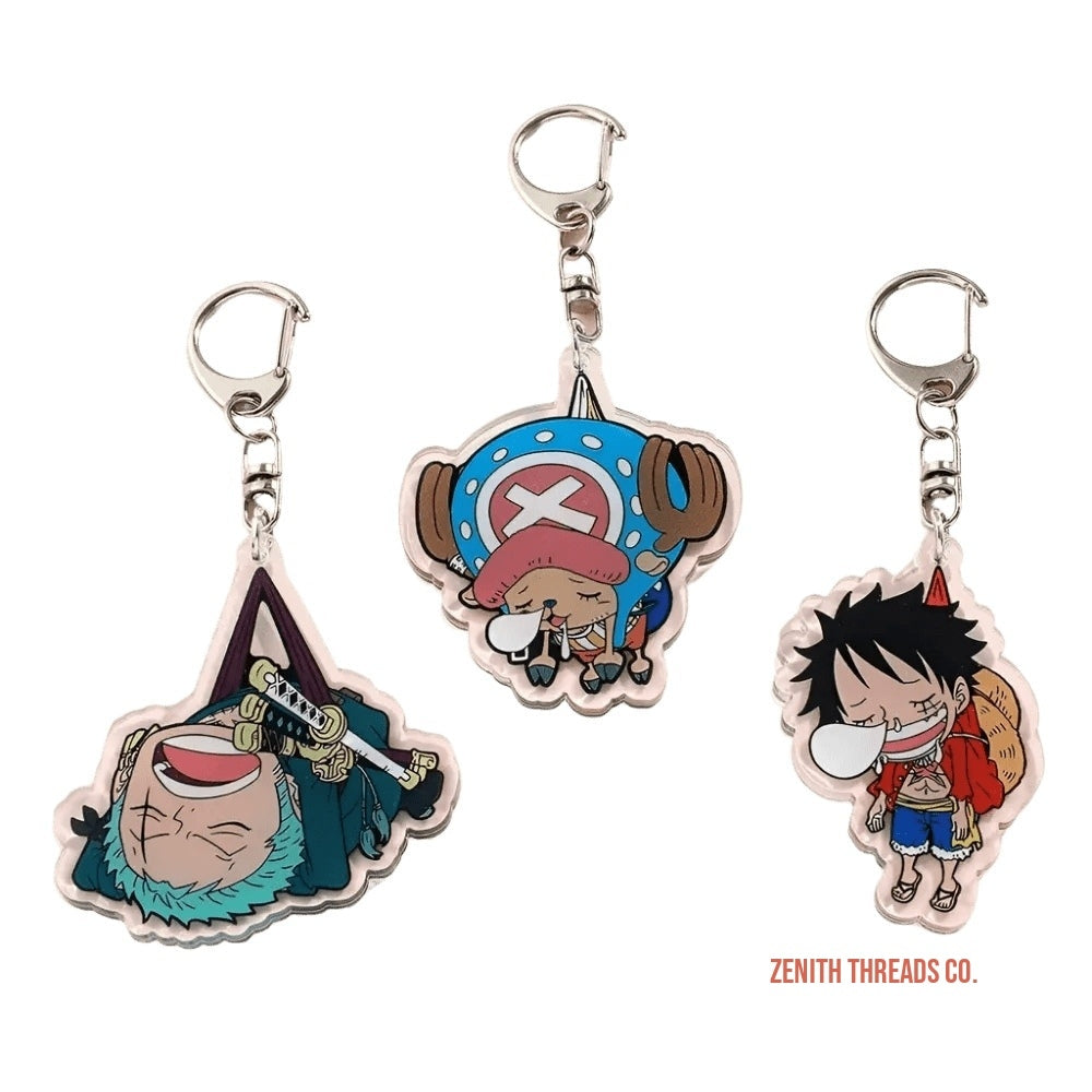 Three anime-style character keychains from the One Piece series.