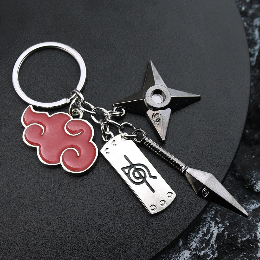 Naruto-themed keychain featuring a red Akatsuki cloud, ninja headband plate, and throwing star charms.