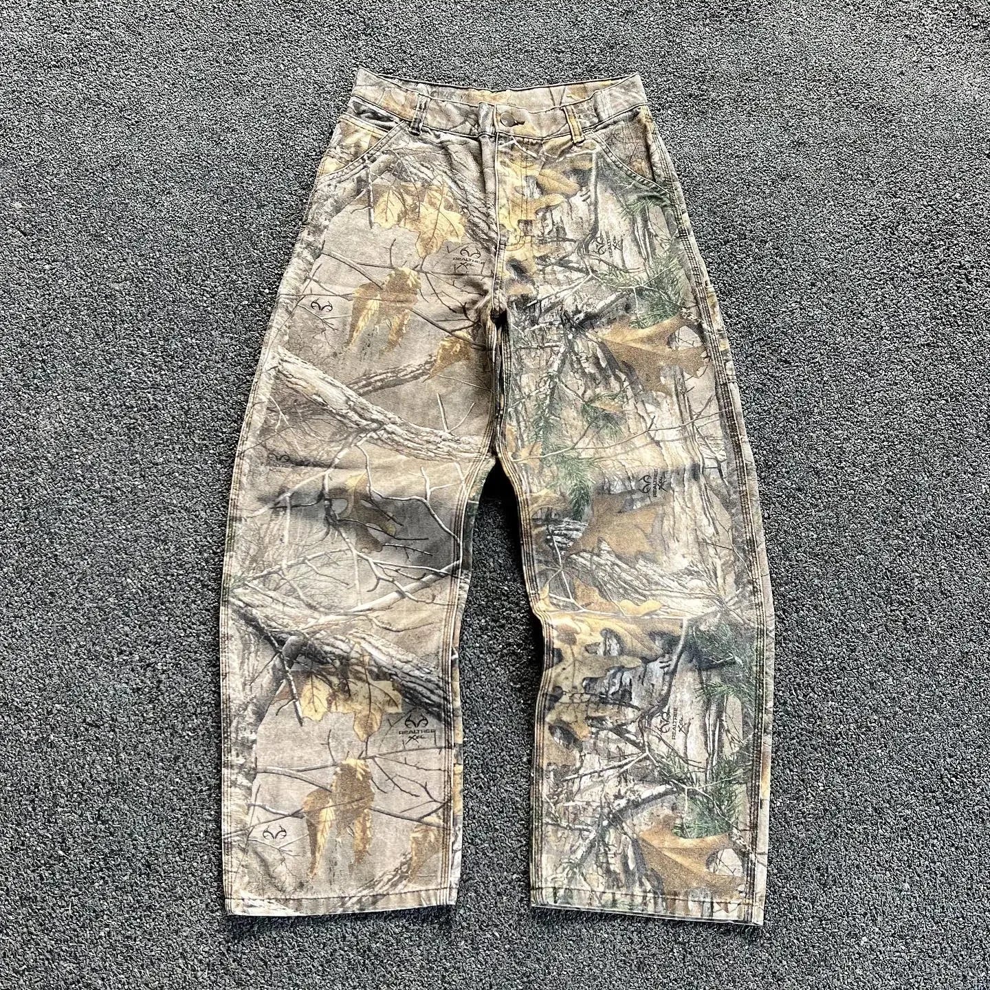 Camouflage hunting pants with a tree bark pattern.