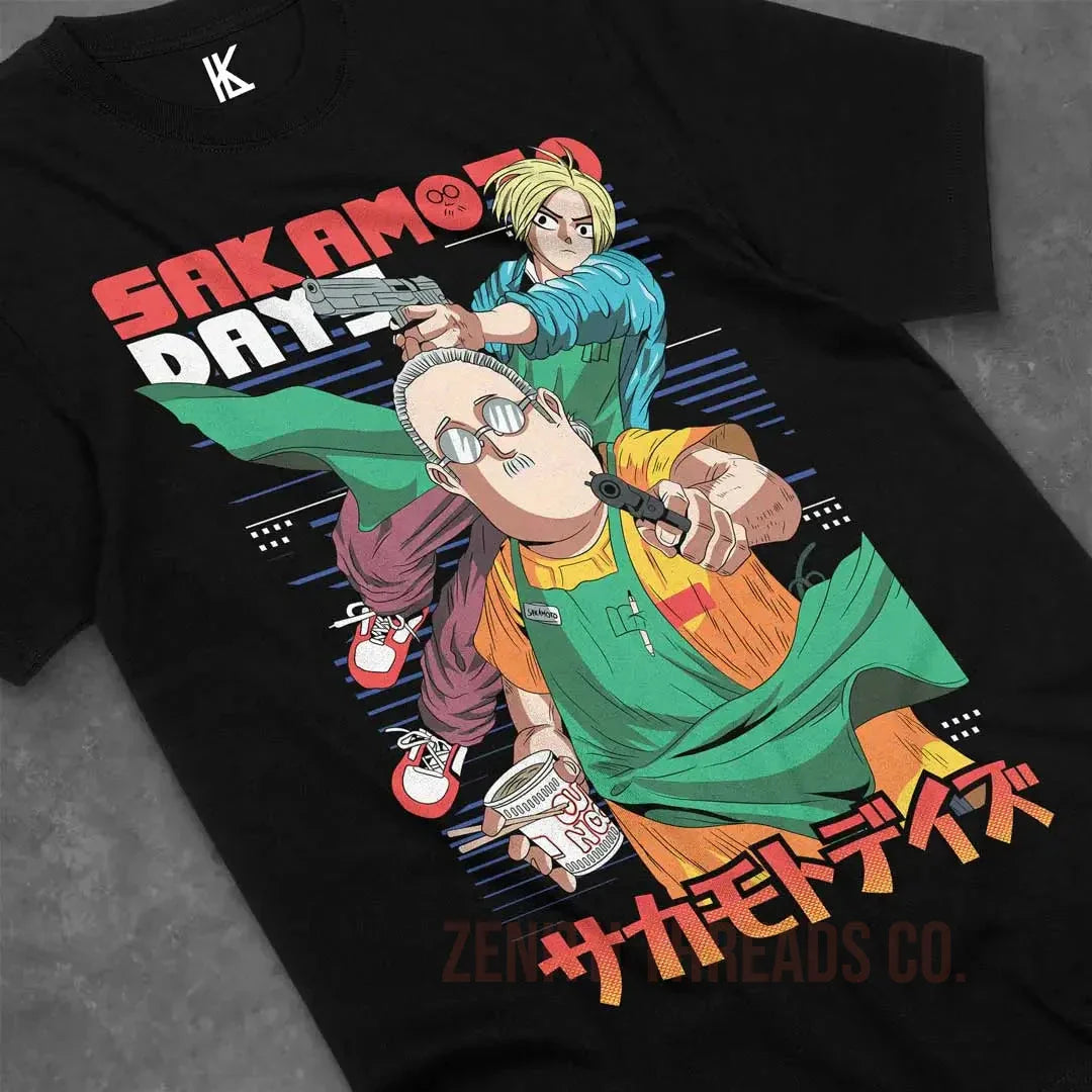 Black t-shirt featuring anime-style artwork with Japanese text and characters in green and orange colors.