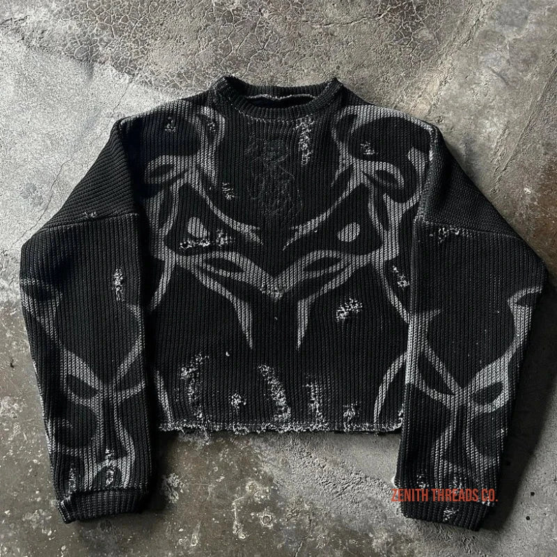 Black cropped sweater with tribal-style gray pattern designs.