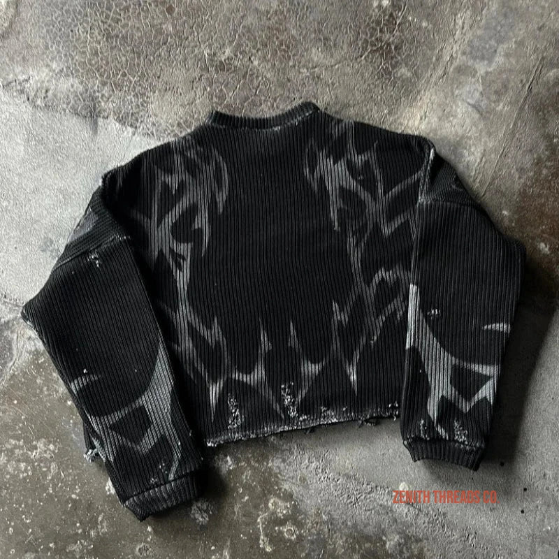 Black cropped ribbed sweater with a distressed or bleached pattern.