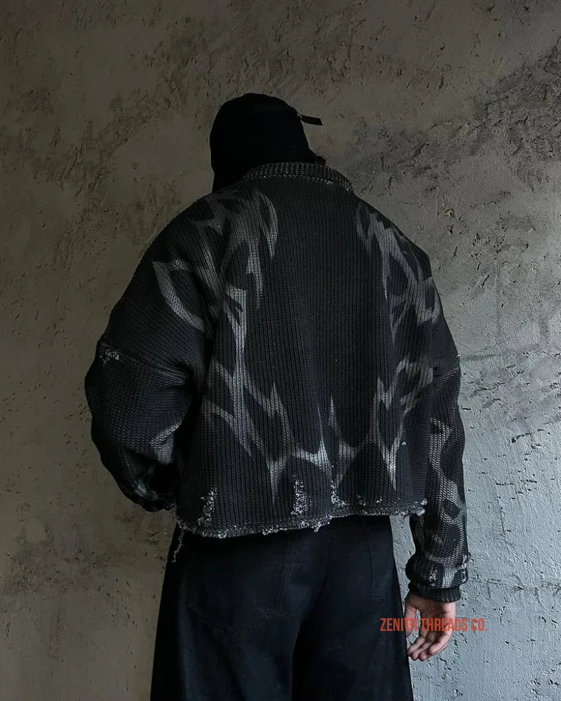 Black patterned puffer jacket with a baseball cap.