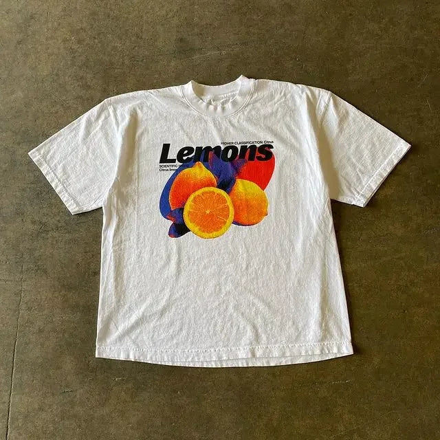 White t-shirt with ’Lemons’ text and colorful citrus fruit graphics printed on the front.