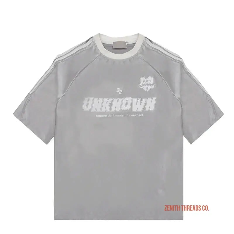 Grey athletic t-shirt with ’UNKNOWN’ text and white trim details.