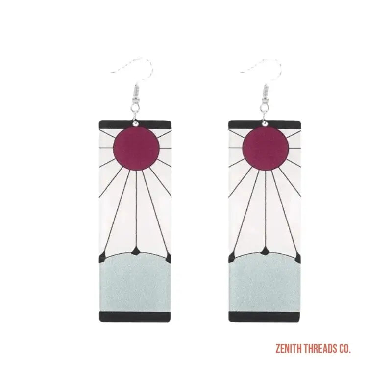 A pair of geometric dangle earrings featuring burgundy circles and mint-colored shapes with black accents.