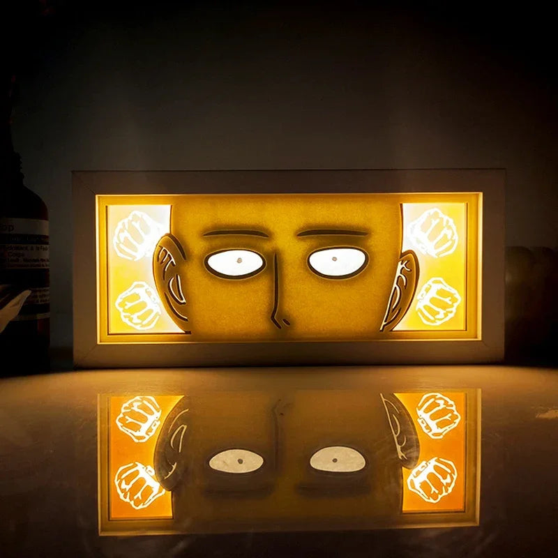 Illuminated Saitama face art in Illumiscene anime shadow light box showcasing paper-cut shadow art