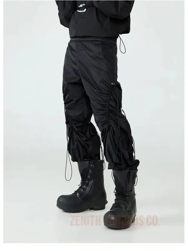 Black cargo pants with drawstring details and ruched sides worn with combat boots.