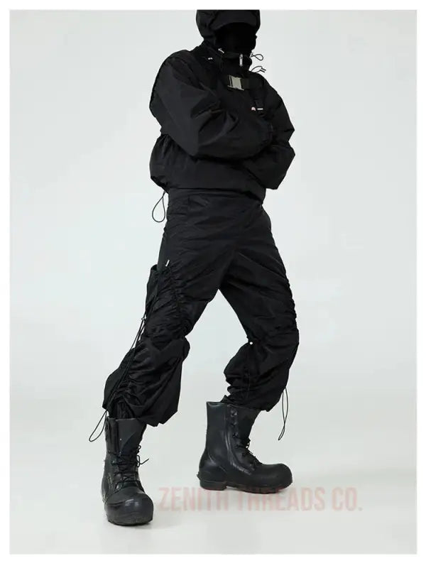 Black tactical combat boots paired with cargo pants and a puffy jacket.