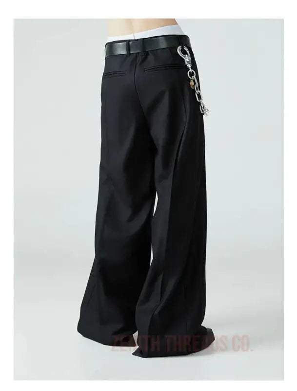 Black wide-leg pants with a chain accessory attached to the belt loop.