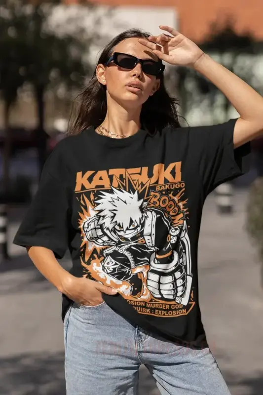 Black graphic t-shirt featuring an orange and white ’Katsuki’ anime-style character design.