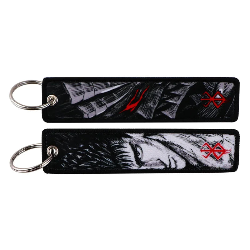 Two Berserk anime embroidery keychains showcasing dark streetwear fashion style