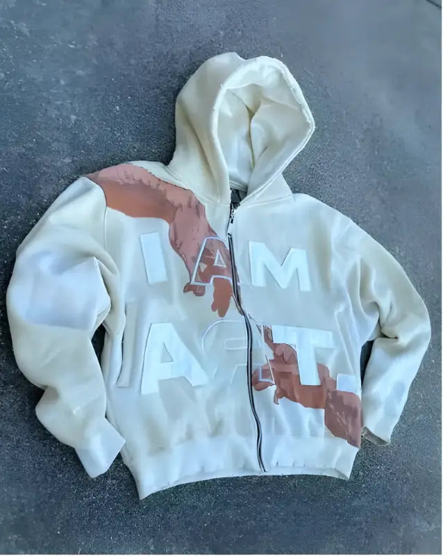 White zip-up hoodie with pink/salmon colored diagonal patches.