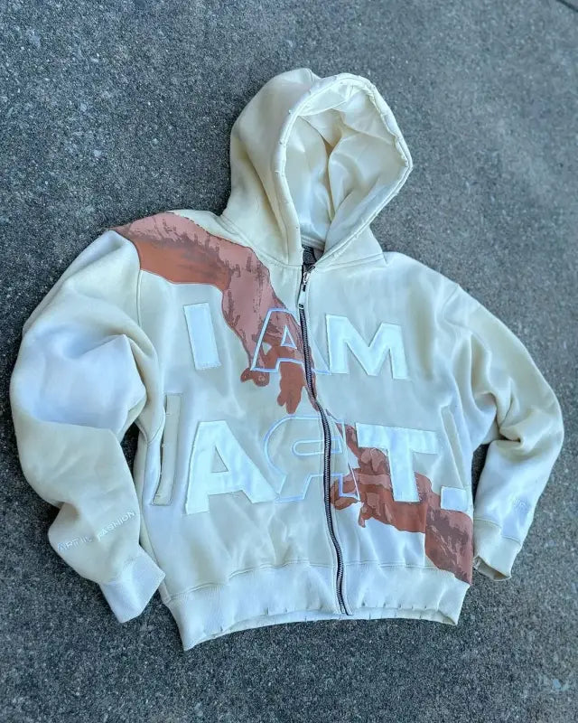 White zip-up hoodie with diagonal brown stains across the front.