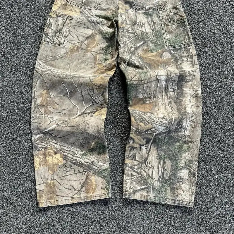 Camouflage cargo pants with a woodland or tree pattern design.