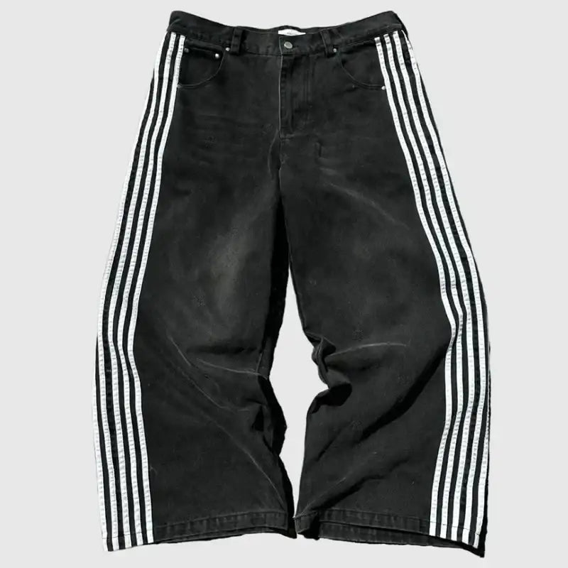 Black denim jeans with three white vertical stripes running down each side.