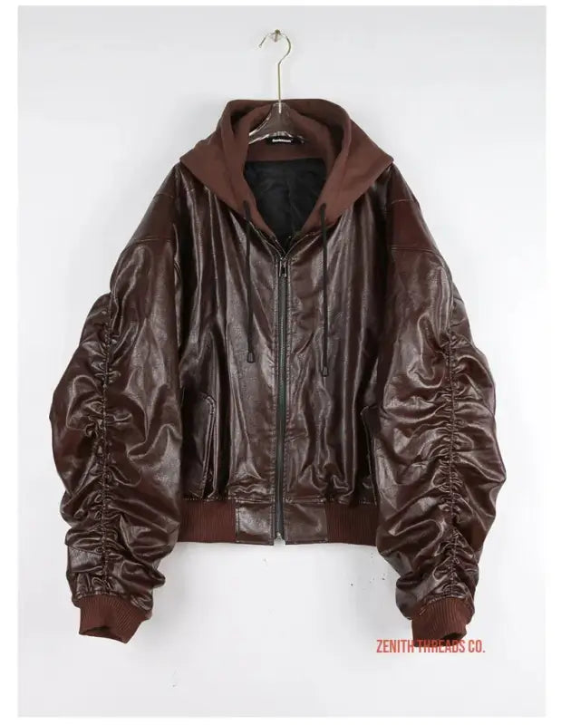 Brown leather bomber jacket with ruched sleeves and ribbed collar.