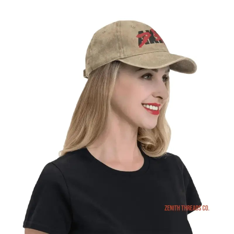 Tan baseball cap with a red logo embroidered on the front.