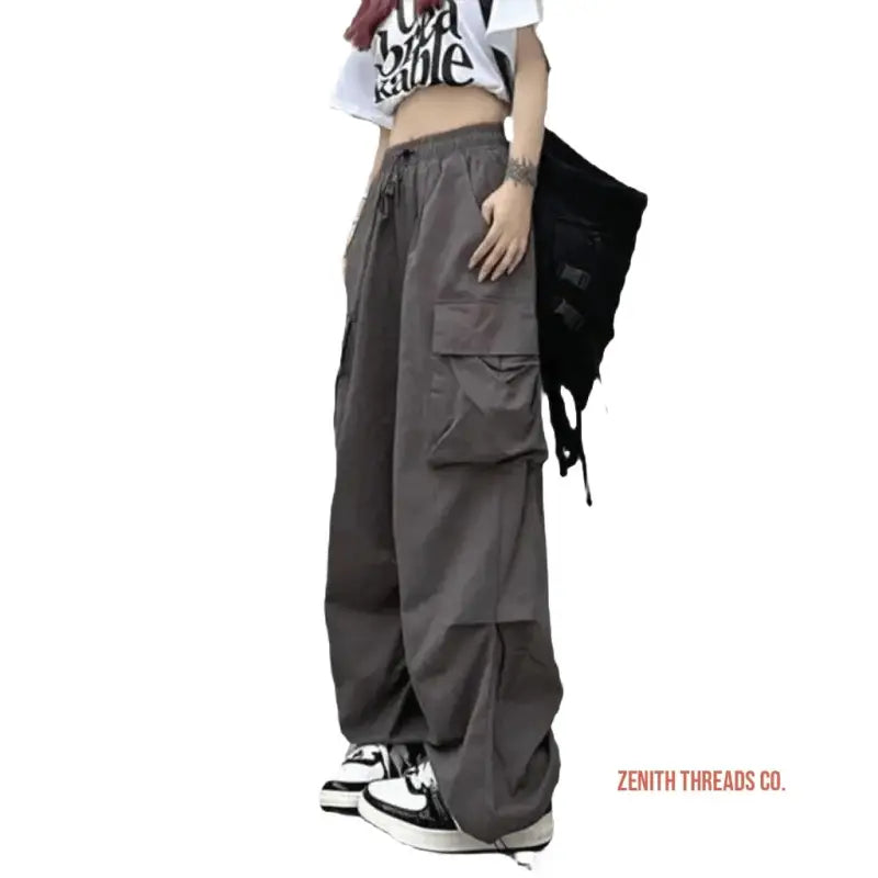 Gray cargo pants with wide legs and side pockets.