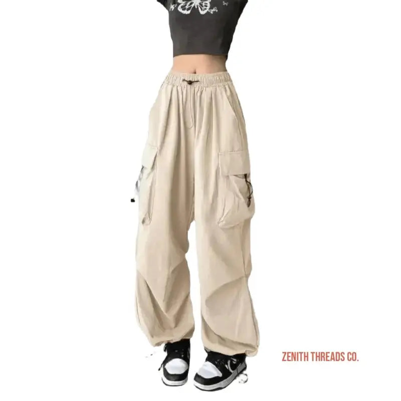 Beige cargo pants with elastic cuffs and multiple side pockets.