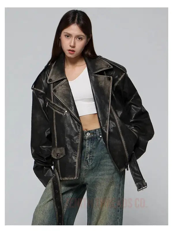 Black leather motorcycle jacket with silver hardware and an oversized fit.