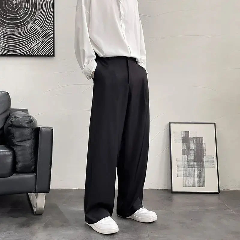 Wide-leg black dress pants paired with white sneakers.