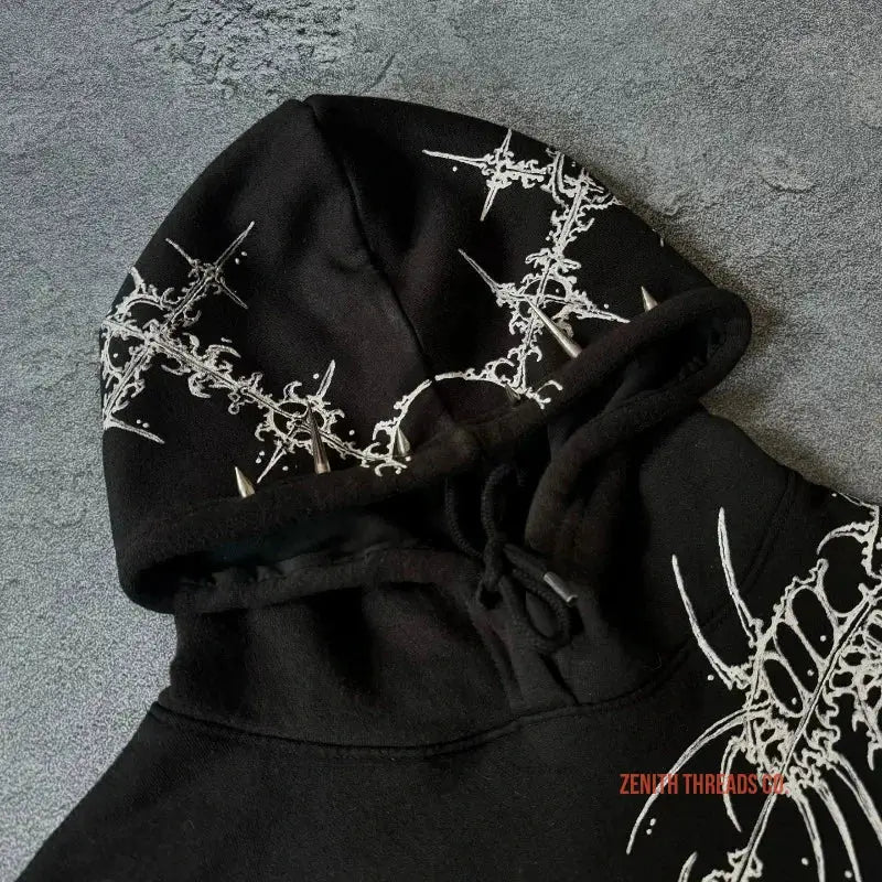 Black hoodie with white gothic-style decorative patterns.