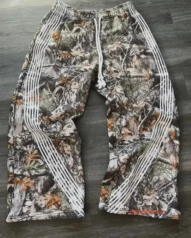 Camouflage pants with white striped details along the sides.