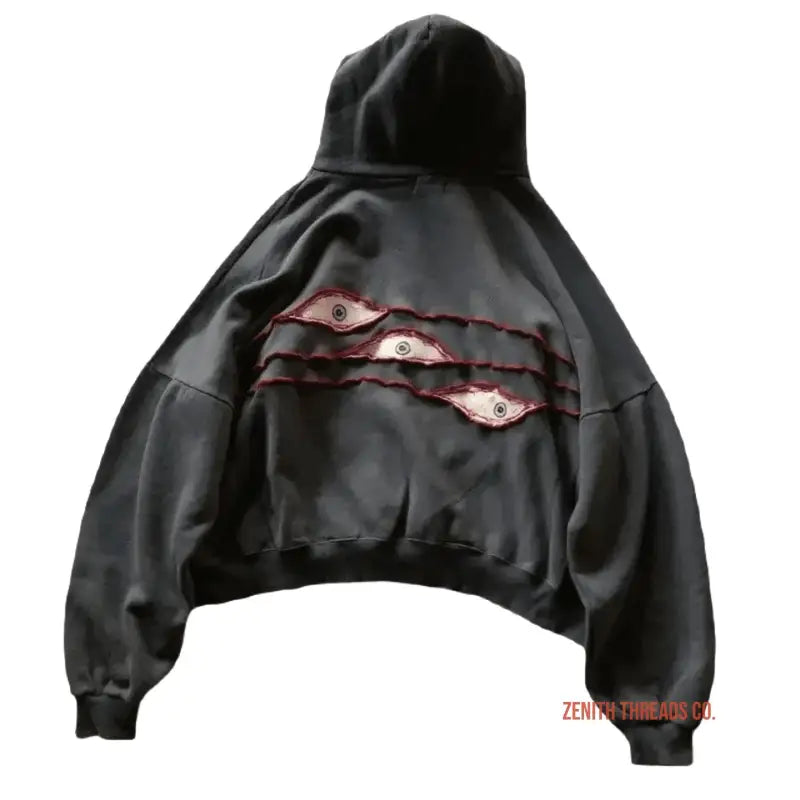 Black hoodie with ripped slashes revealing pink fabric underneath.