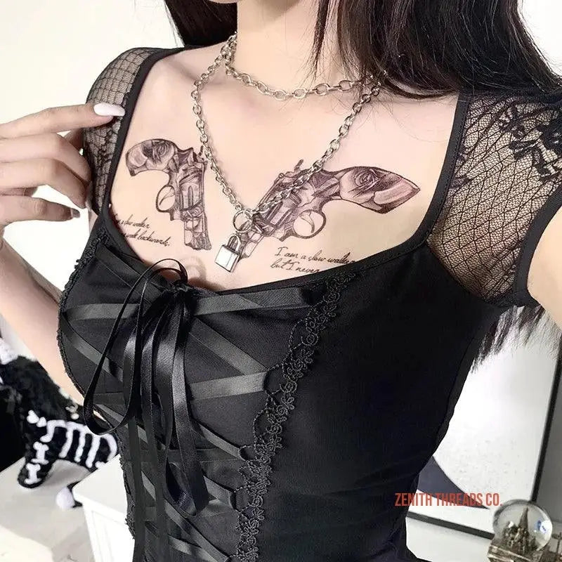 Black lace-trimmed corset top with gun-themed tattoo artwork visible on the chest.