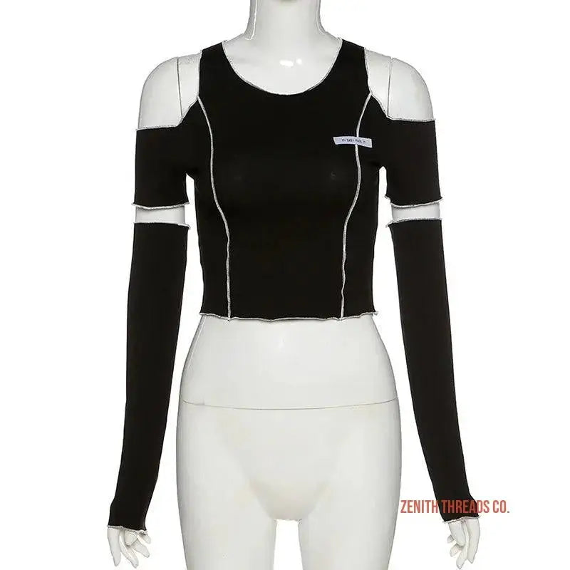 Black long-sleeved crop top with white trim and cutout shoulders.