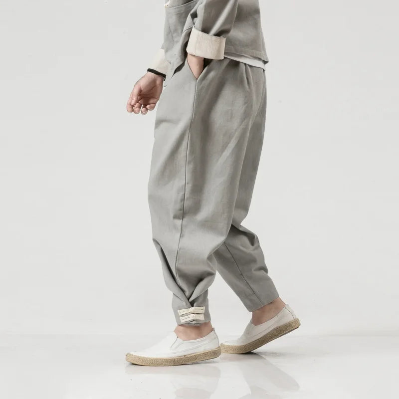 Gray loose-fitting trousers complement a Timeless Chinese style jacket inspired by Tang Dynasty fashion