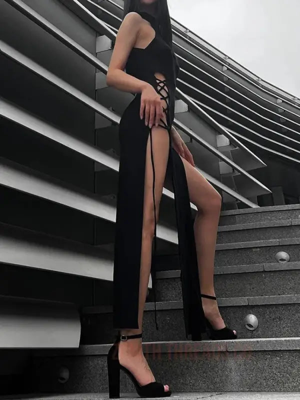 Long black dress with a high side slit and platform heels.