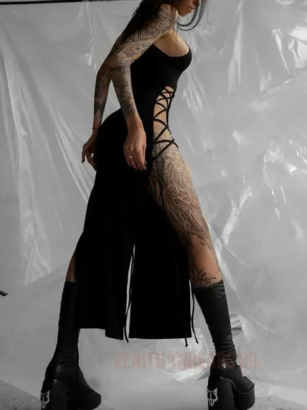 Gothic-style black dress with side lacing and thigh-high socks paired with platform boots.