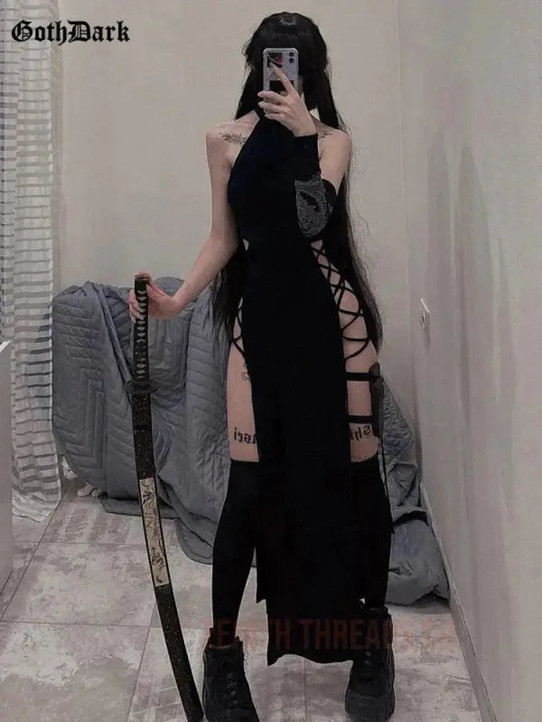 Long black gothic dress with side lace-up details and strappy design.