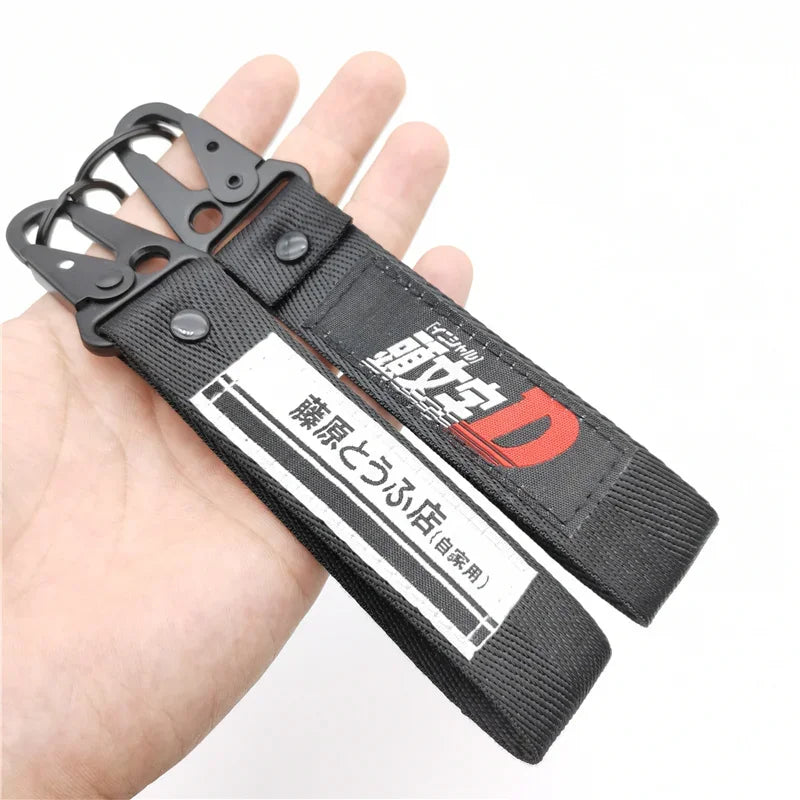 Two black Initial D keychains from anime-inspired JDM item for street racing fans