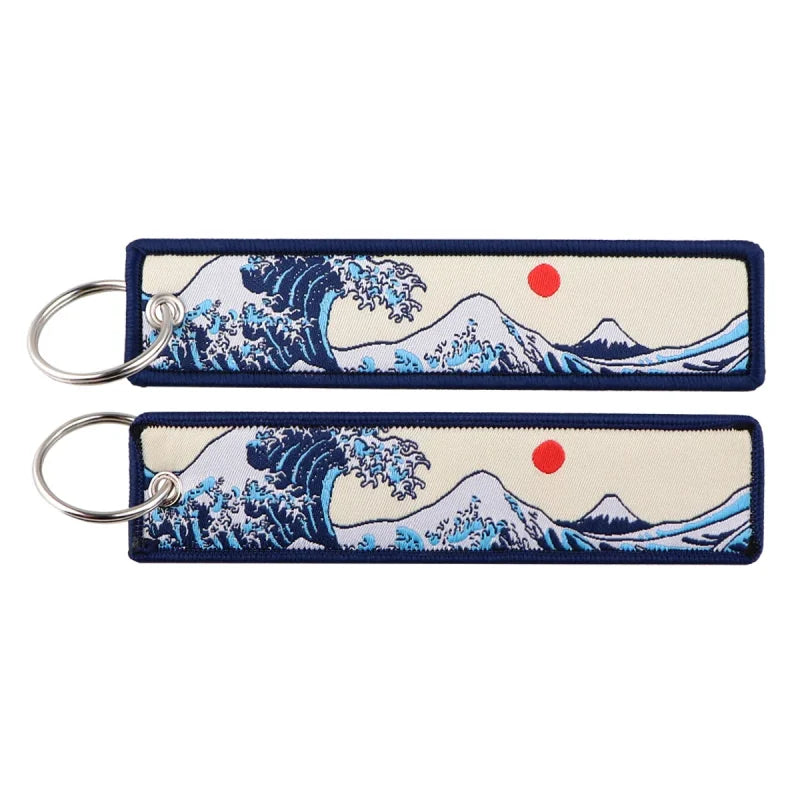 Two Japanese waves embroidered zinc alloy keychains displayed in a set