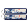 Two Japanese waves embroidered zinc alloy keychains displayed in a set