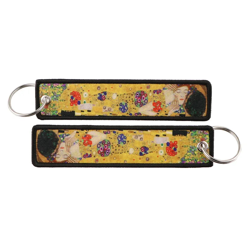 Two rectangular zinc alloy keychains featuring Japanese waves embroidered artwork