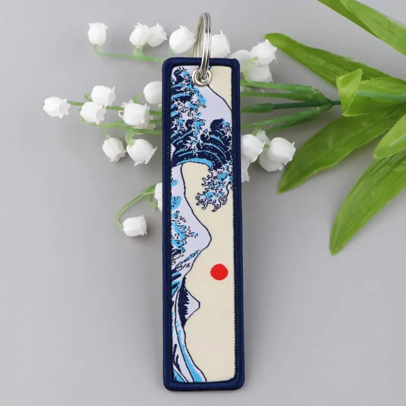 Rectangular zinc alloy keychain with Japanese waves embroidered design