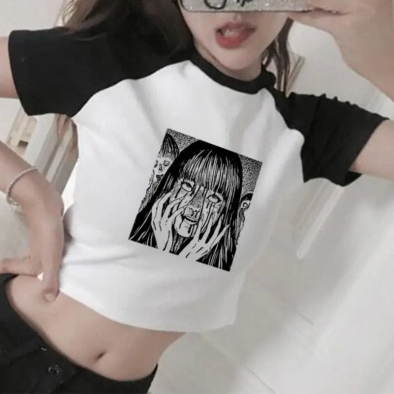 White and black cropped t-shirt featuring manga-style horror artwork on the front.