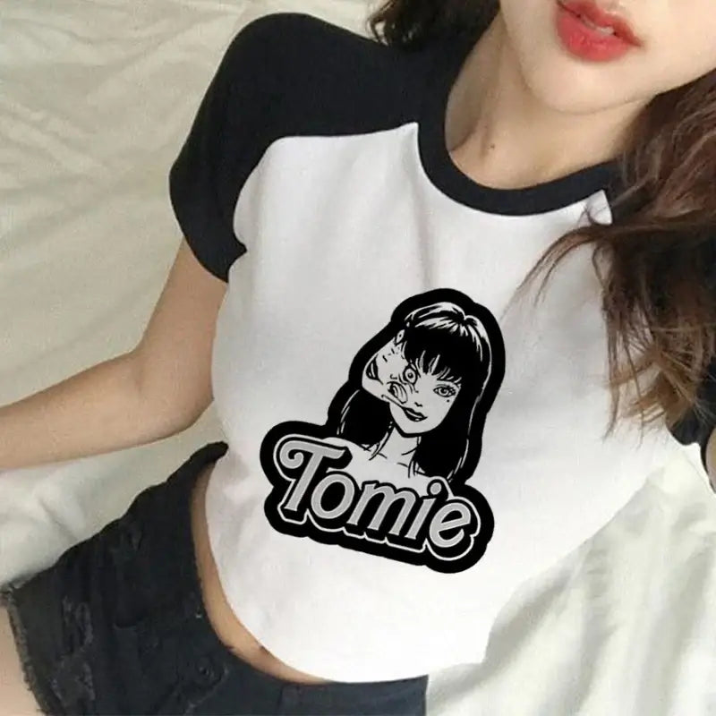 White raglan t-shirt with black sleeves featuring a ’Tomie’ graphic design.